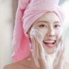 Asian woman washes her face with towel in the head