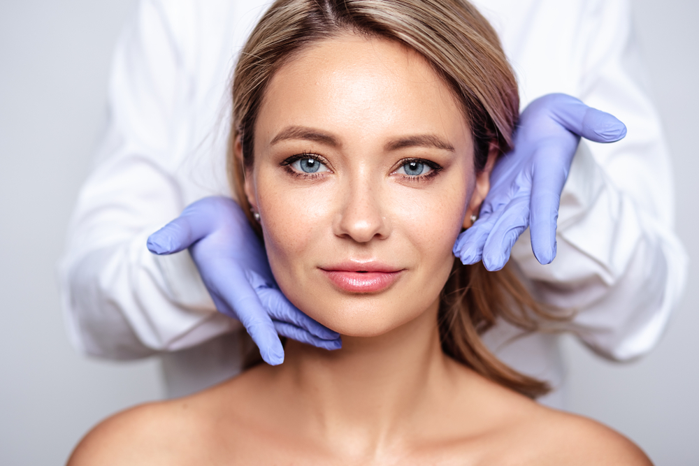 Woman with glowing skin after DermaSweep treatment with her esthetician