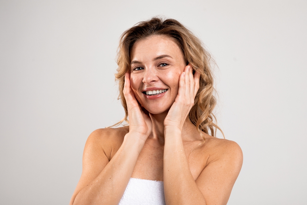 Mature woman with glowing skin after microneedling treatment